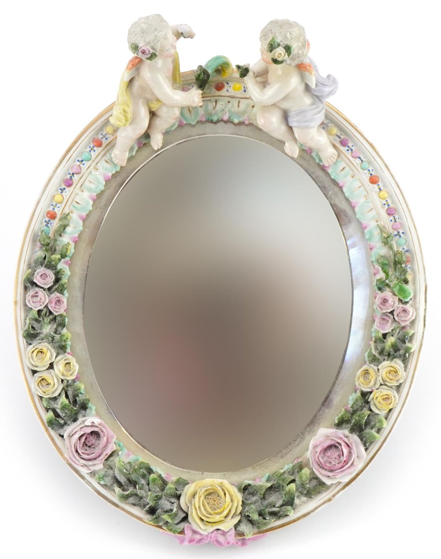 Dresden, German porcelain oval easel floral encrusted mirror having bevelled glass surmounted with