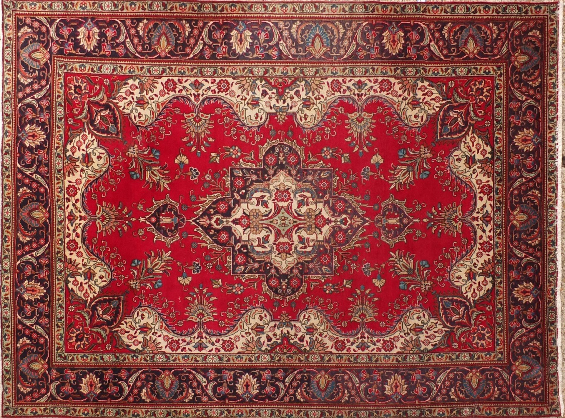 Hand made Iranian carpet with stylised floral pattern onto a red and blue ground, 354cm x 254cm :