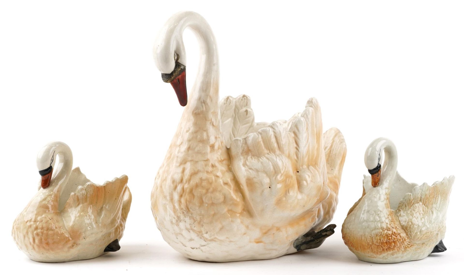 Three hand painted ceramic planters in the form of swans, the largest 44cm in length : For further