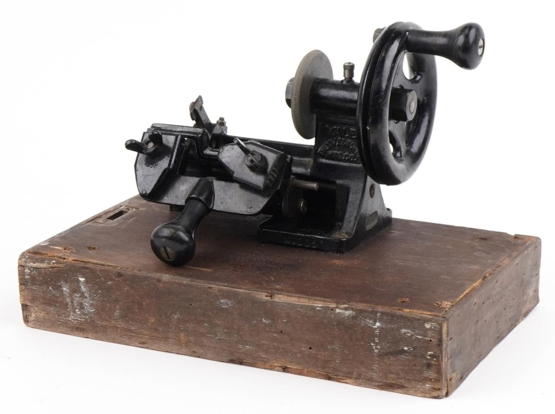 Early 20th century Yale cast iron key cutting machine on rectangular wooden base, overall 34cm