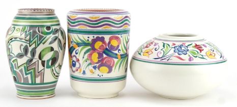 Three Mid century Poole pottery vases hand painted with stylised flowers including one in the GPA