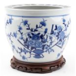 Chinese blue and white porcelain jardiniere on hardwood stand hand painted with flowers and fan