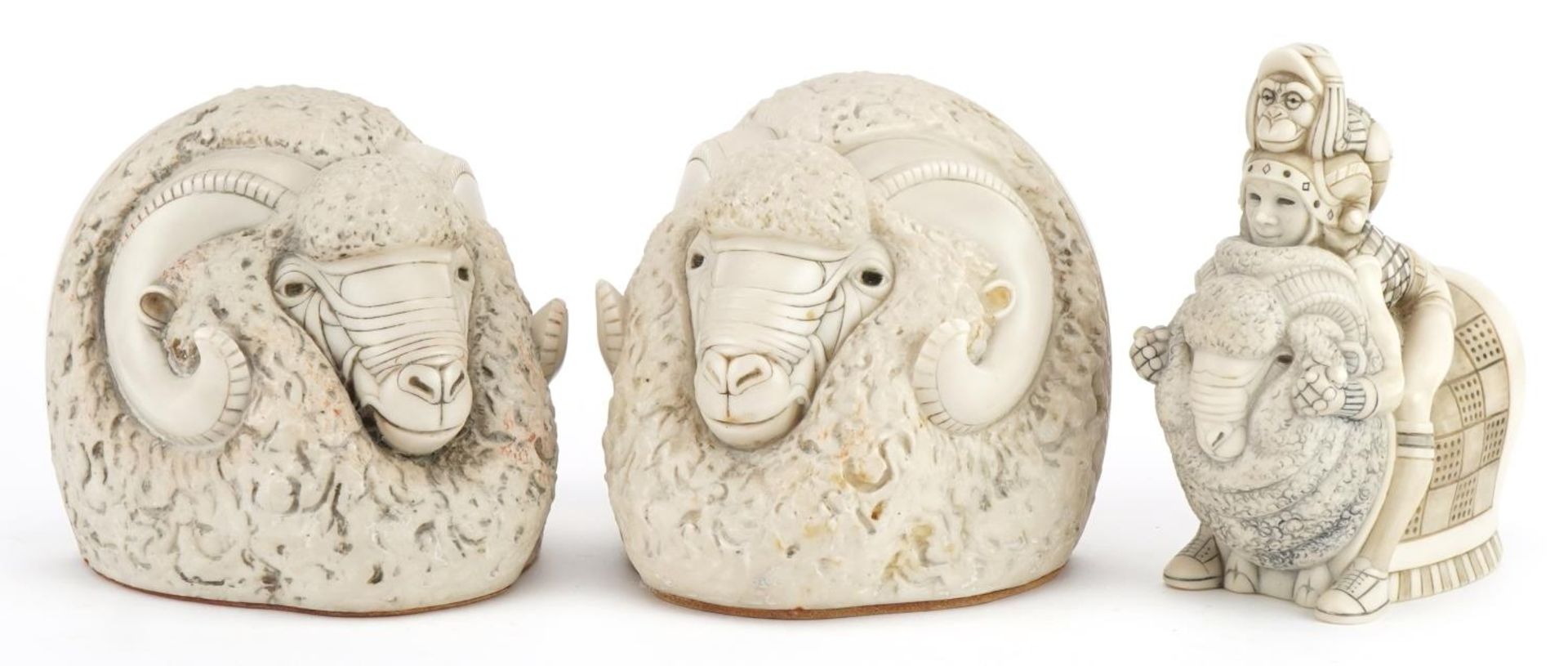 Pair of mid century style stylised ram's head design bookends and a similar figure group, the