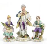 Three continental porcelain figures including a pair of German floral encrusted flower sellers by