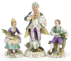 Three continental porcelain figures including a pair of German floral encrusted flower sellers by