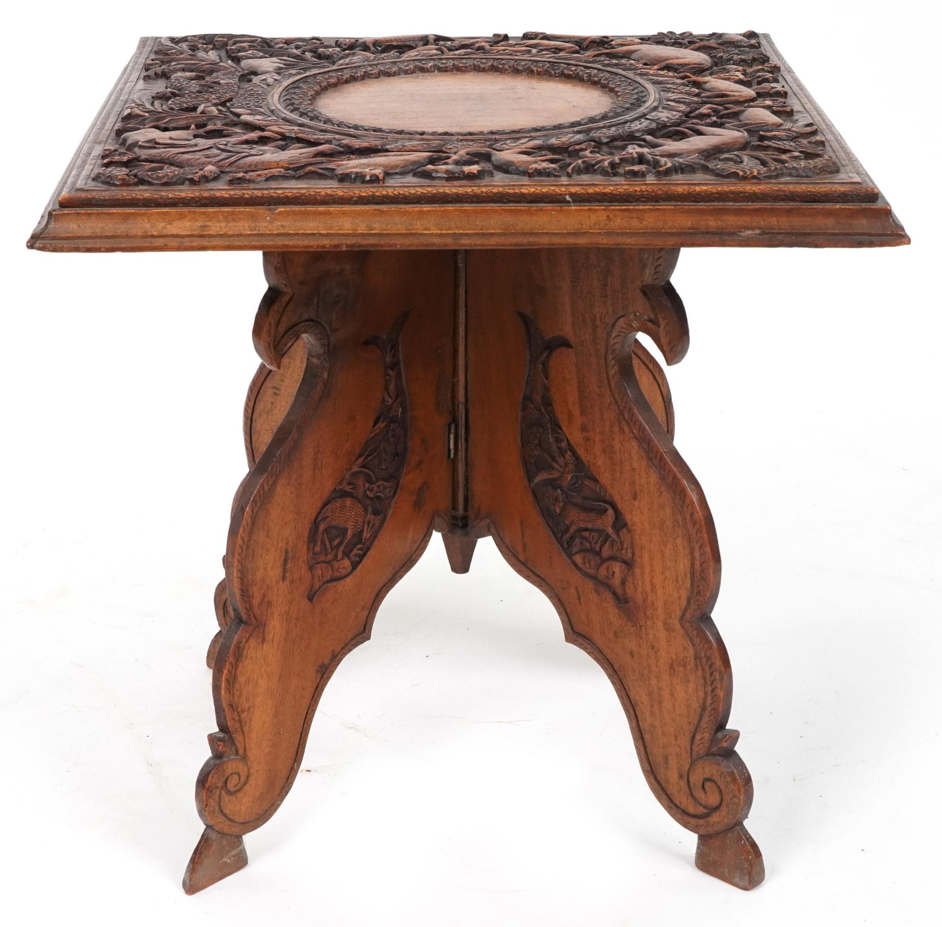 Anglo Indian hardwood folding side table, finely and deeply carved with an elephant and wild animals - Image 2 of 4