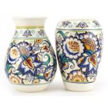 Karen Brown for Poole Pottery, two Mid century studio vases hand painted with stylised flowers in