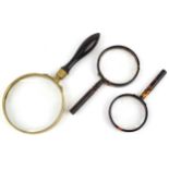 Three antique and later magnifying glasses including a Regency gallery example with rosewood handle,