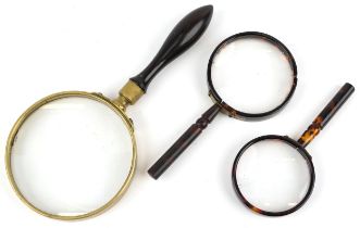 Three antique and later magnifying glasses including a Regency gallery example with rosewood handle,