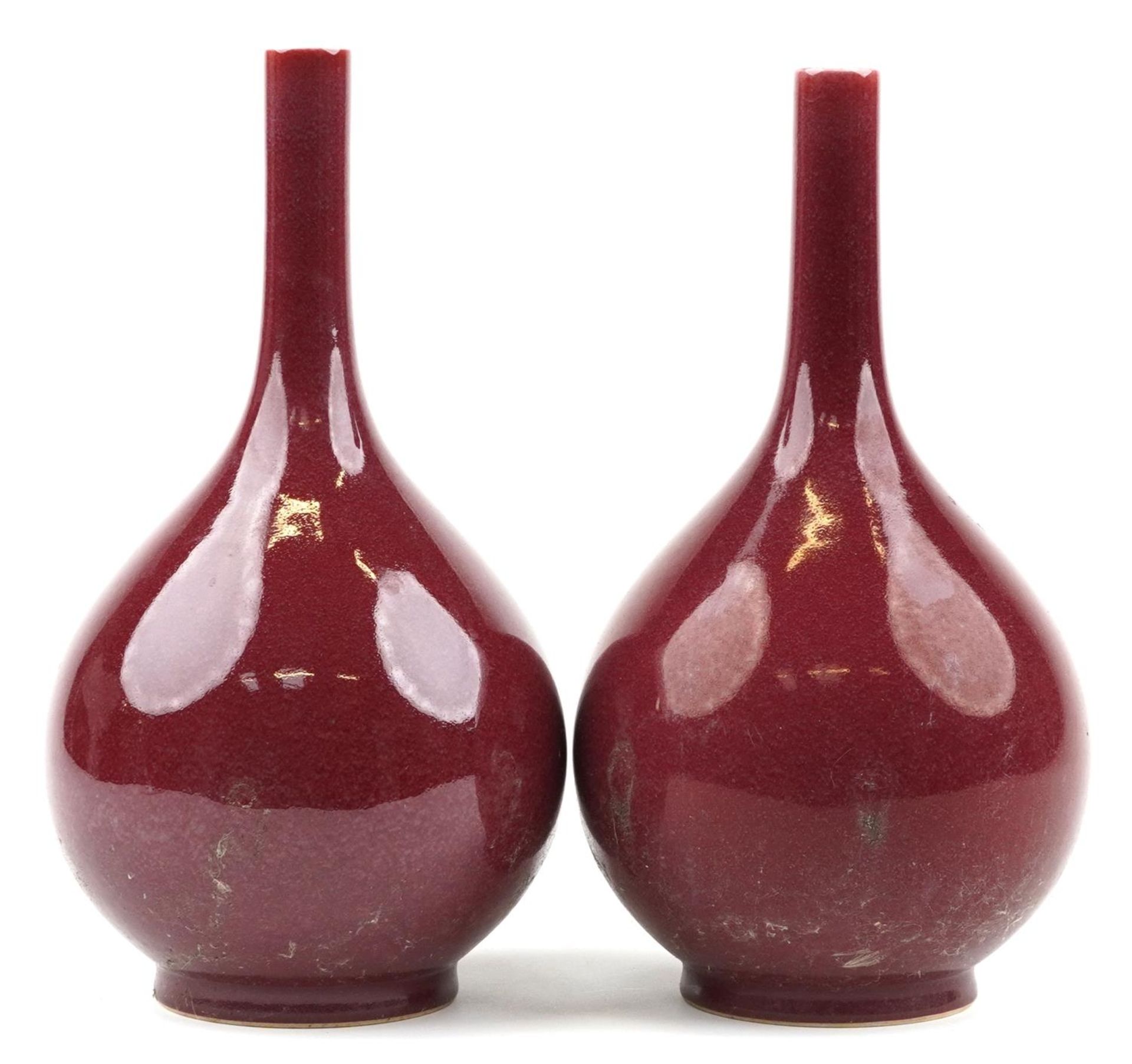 Pair of Chinese porcelain long neck bottle vases having sang de boeuf glazes, each 34cm high : For - Image 4 of 6