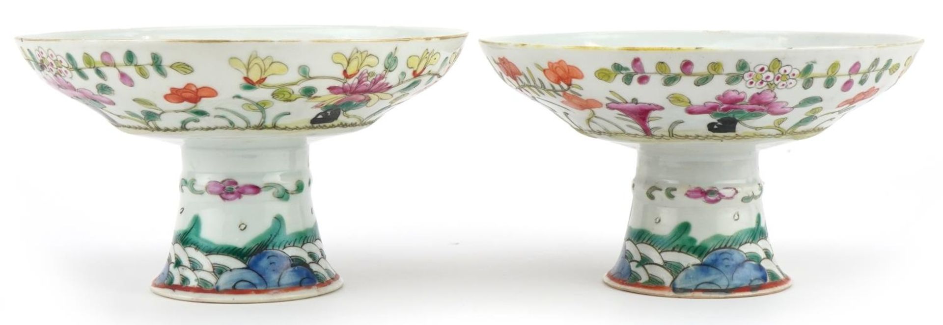 Pair of Chinese porcelain stem bowls hand painted in the famille rose palette with flowers, each 9.