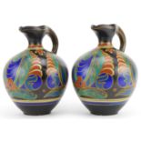 Gouda, pair of Dutch Art Nouveau ewers hand painted with stylised flowers, each numbered 1785 to the