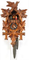 Lotscher, German Black Forest cuckoo clock carved with foliage, having circular dial with Romance