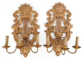 Pair of 19th century French gilt wood three branch wall sconces in the form of a lyres, each 61cm