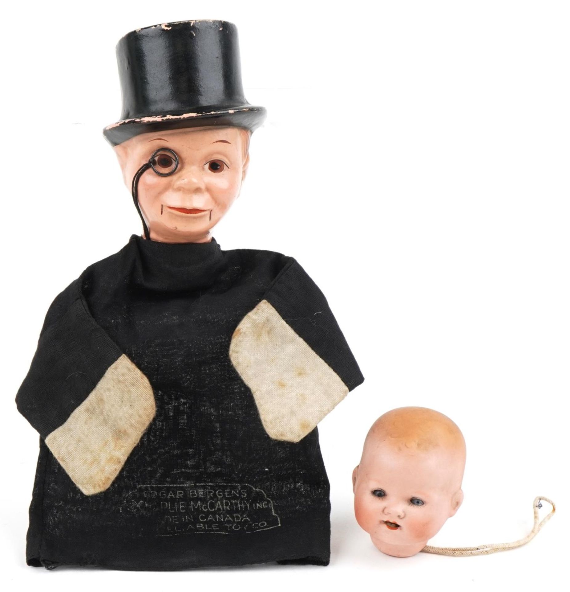 Vintage Edgar's Bergen's Charlie McCarthy glove puppet and an Armand Marseille bisque doll's head,