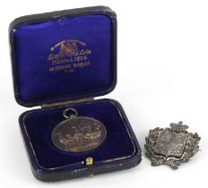 1887 silver jubilee pin badge and a silver jewel cast with poultry housed in a fitted case, total