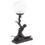 Bronzed table lamp with frosted globular glass shade in the form of a semi nude Art Deco dancer,