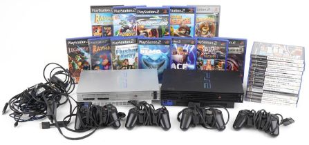 Two Sony PlayStation 2 games consoles with controllers and various games including League of