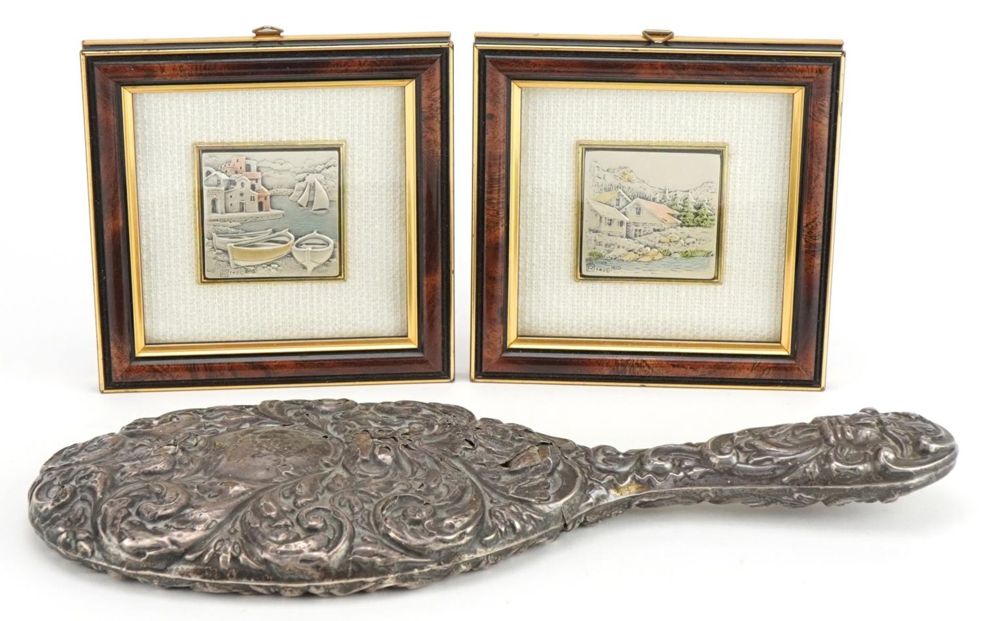 Pair of Cadeor Italian silver plaques housed in glazed frames and a silver backed hand mirror