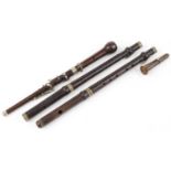 Three Victorian rosewood flute sections and a horn mouthpiece, of the pieces impressed Butler