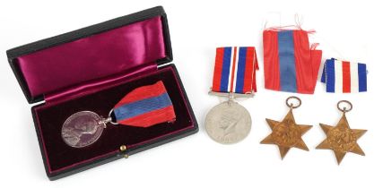 Three British military World War II medals and a George V Faithful Service medal with fitted case