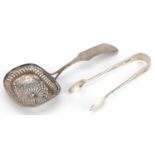 Dutch silver sifting spoon and a pair of silver sugar tongs, the largest 16.5cm in length, total