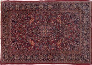 Rectangular Persian Sarouk type part silk red ground rug having an allover floral design, 214cm x