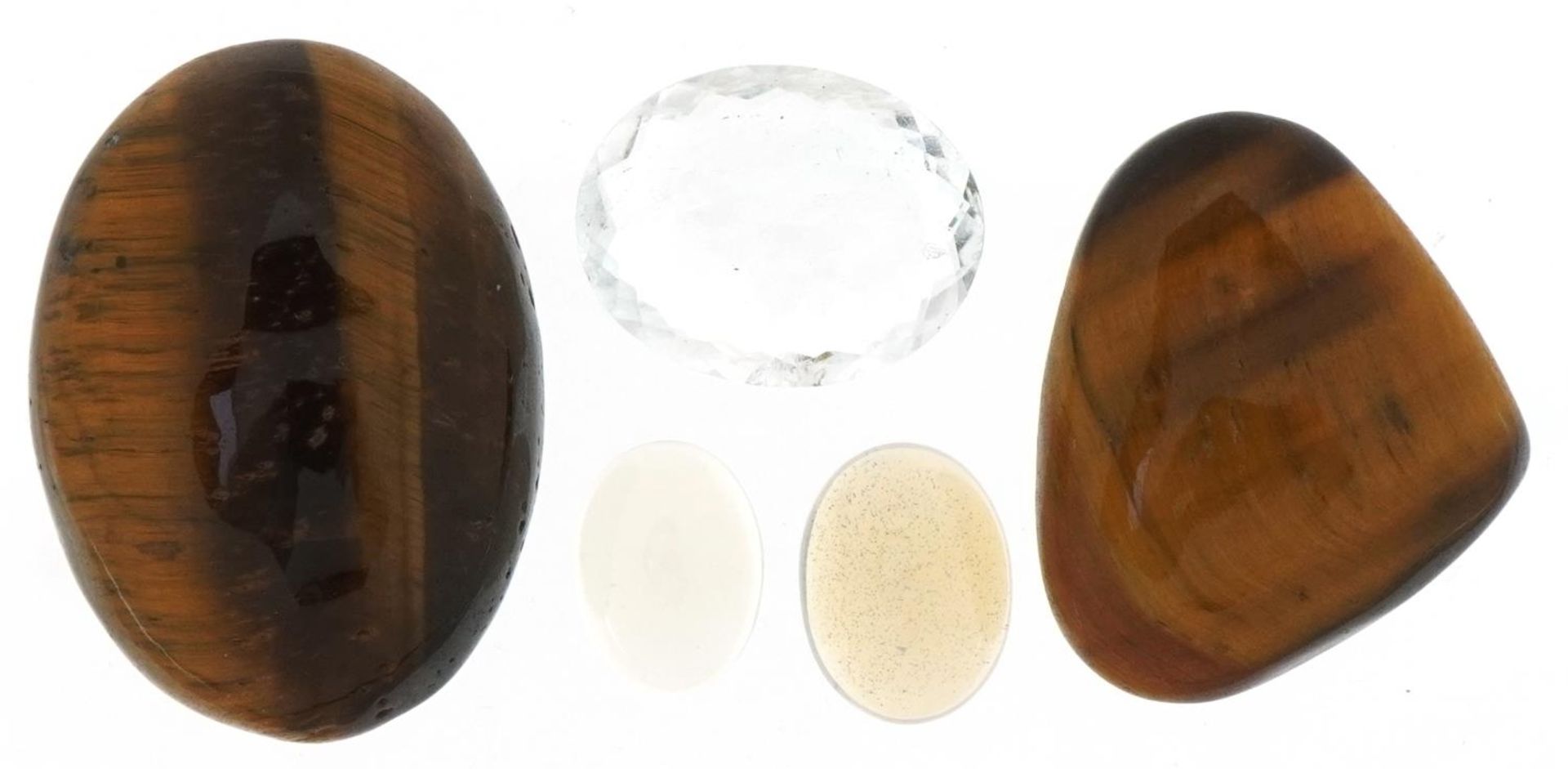Five natural gemstones with certificates comprising white fire opal, tiger's eye and aquamarine :