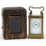 Miniature brass cased carriage clock with case, the circular dial having Roman numerals, the