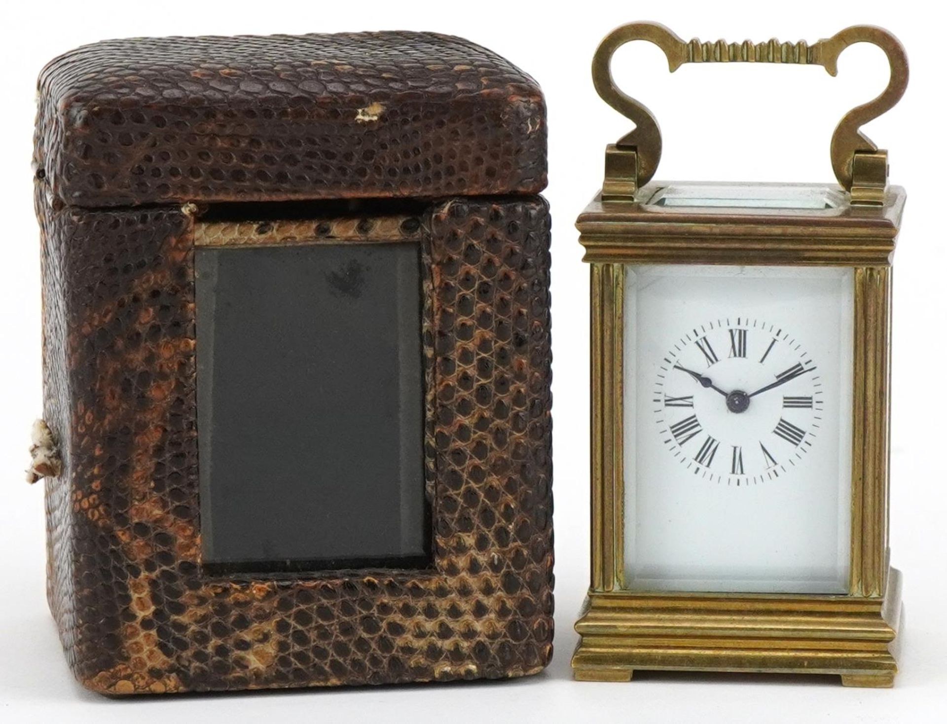 Miniature brass cased carriage clock with case, the circular dial having Roman numerals, the