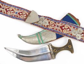 Omani Jambiya dagger with horn handle and white metal mounts on embroidered belt, the dagger 39.