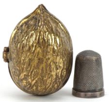 Victorian brass thimble case in the form of an acorn housing a silver thimble, the case 4.5cm high :