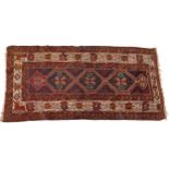 Rectangular Turkish red ground rug having an allover repeat floral design, 258cm x 132cm : For