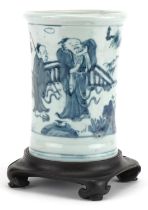 Chinese blue and white brush pot on hardwood stand hand painted with figures in a landscape, overall