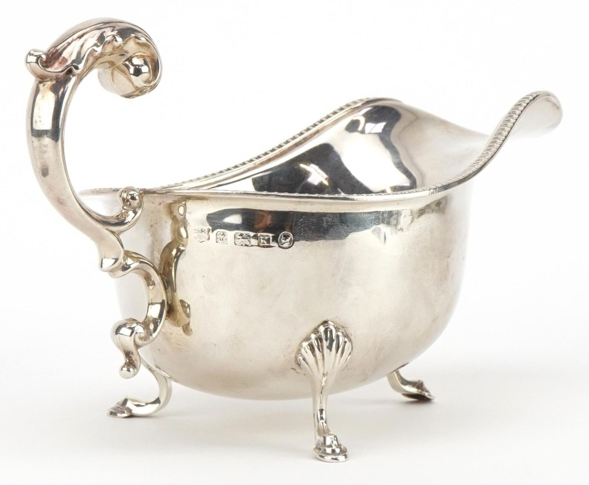 S Blanckensee & Son Ltd, George V silver three footed sauceboat, Birmingham 1934, 17cm in length, - Image 2 of 4
