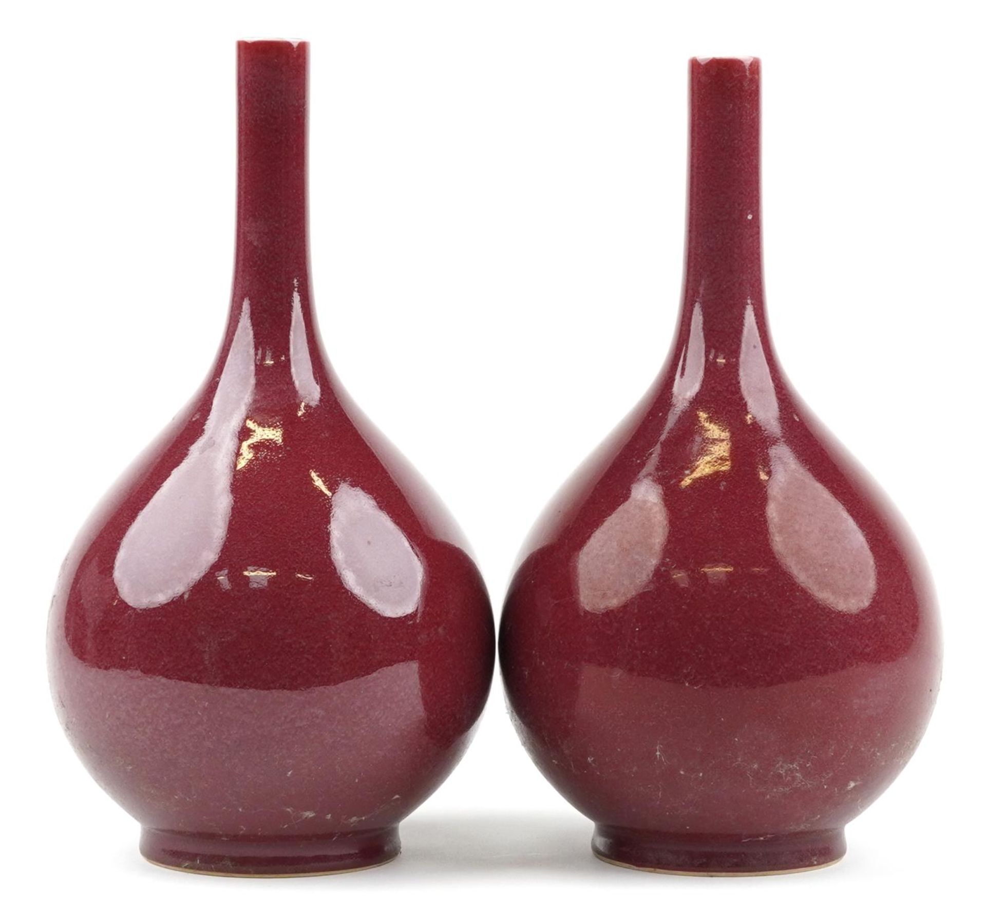 Pair of Chinese porcelain long neck bottle vases having sang de boeuf glazes, each 34cm high : For - Image 2 of 6