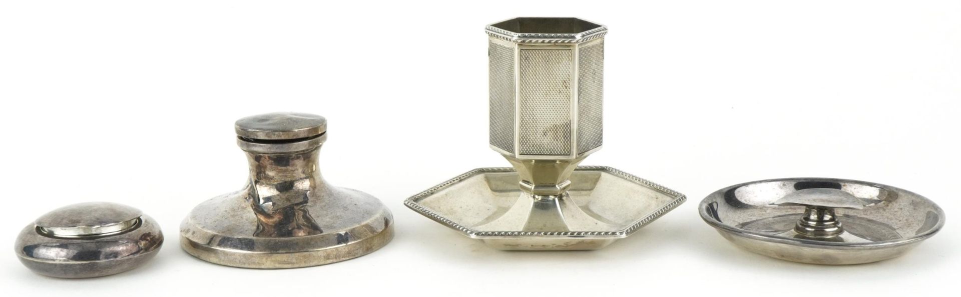 Silver objects including an engine turned match stand and a capstan inkwell, the largest 7.5cm high,