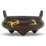 Chinese gold splashed patinated bronze tripod censer with twin handles, four figure character