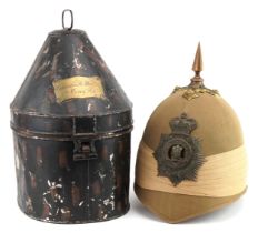 Victorian military interest pith spike top type helmet with Welsh helmet badge housed in a tin case,