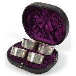 Levesley Brothers, set of four Victorian engraved circular silver napkin rings housed in a velvet