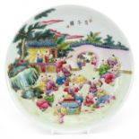 Chinese porcelain shallow dish hand painted in the famille rose palette with children playing in a