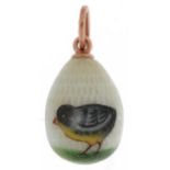 14ct gold guilloche enamel egg pendant hand painted with a chick, impressed Russian marks, 2.5cm