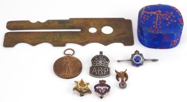 Militaria including brass button cleaner, silver and enamel Royal Army Service Corps sweetheart