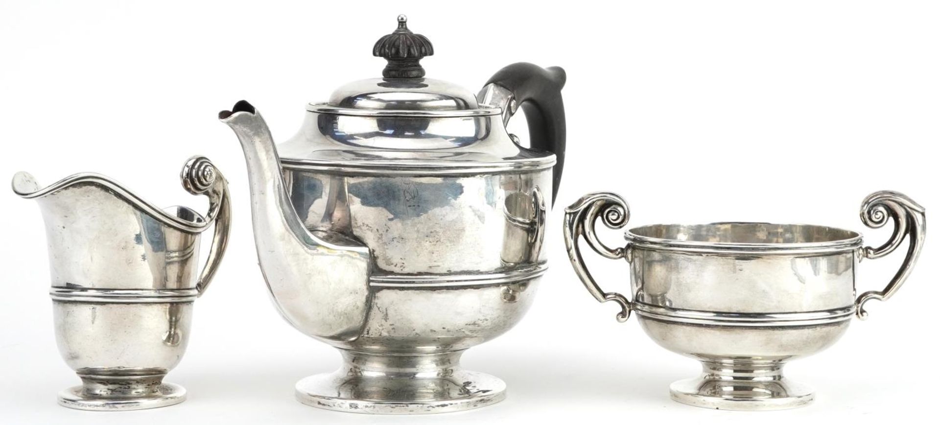 George Nathan & Ridley Hayes, Edwardian silver three piece tea service, the teapot with ebonised