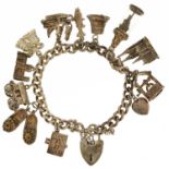 Silver charm bracelet with silver love heart padlock and a selection of mostly silver charms, 61.