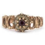 9ct gold garnet and clear stone flower head ring with pierced bark design shoulders, size I, 2.