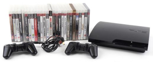 Sony PlayStation 3 games console with two controllers and a collection of games : For further