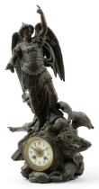 Verdigris patinated spelter mantle clock in the form of Saint Michael and demon, having circular