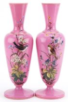 Pair of Victorian aesthetic pink opaline glass vases enamelled with birds amongst flowers, 32cm high