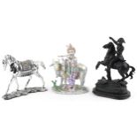 Three horse sculptures including a patinated spelter example of a soldier on horseback, the
